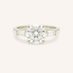 White gold Stately Manor round diamond three stone engagement ring with baguette accents front view