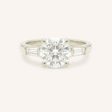 White gold Stately Manor round diamond three stone engagement ring with baguette accents front view