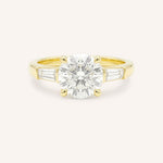 Yellow gold Stately Manor round diamond three stone engagement ring with baguette accents front view