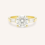 Yellow gold Stately Manor round diamond three stone engagement ring with baguette accents front view