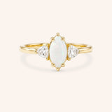 Yellow gold Cassidy marquise opal and trillion diamond engagement ring front view on white background