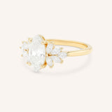 Yellow gold Emme marquise diamond cluster engagement ring side view on white background