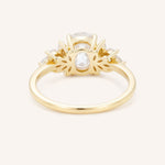 Yellow gold Emme oval diamond cluster engagement ring back view on white background