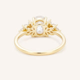 Yellow gold Emme oval diamond cluster engagement ring back view on white background