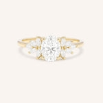 Yellow gold Emme oval diamond cluster engagement ring front view on white background