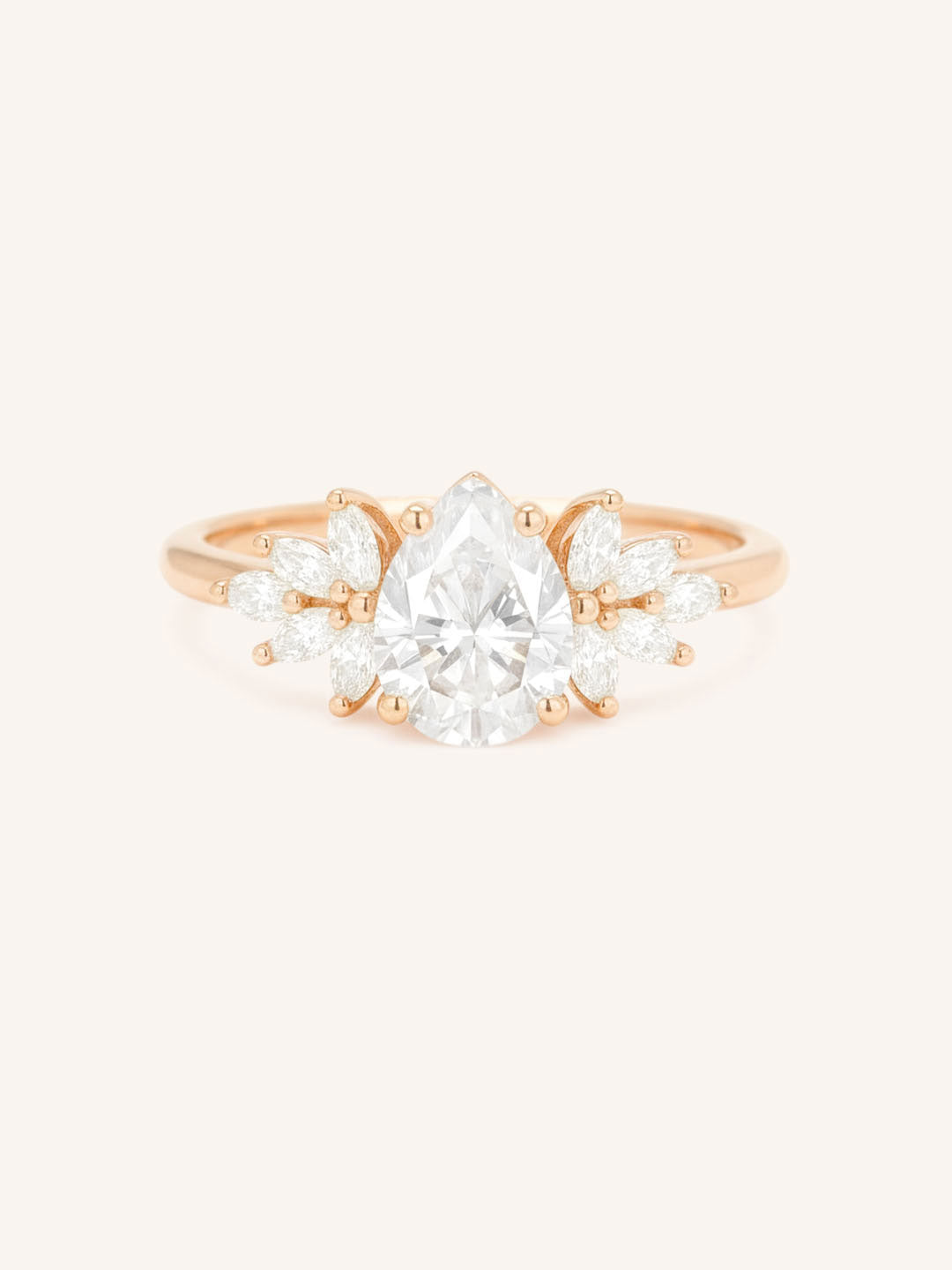 Rose gold Emme pear diamond cluster engagement ring front view on white background