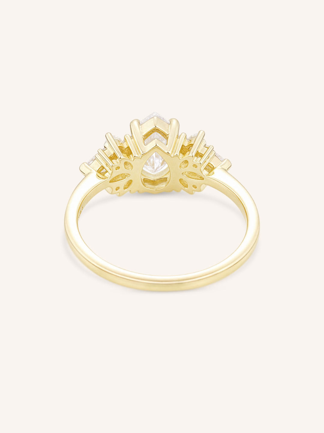 Yellow gold Emme pear diamond cluster engagement ring back view on white background