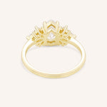 Yellow gold Emme pear diamond cluster engagement ring back view on white background