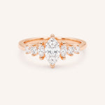 Rose Gold marquise diamond ring with graduated marquise and round side stones on white background