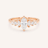 Rose Gold marquise diamond ring with graduated marquise and round side stones on white background