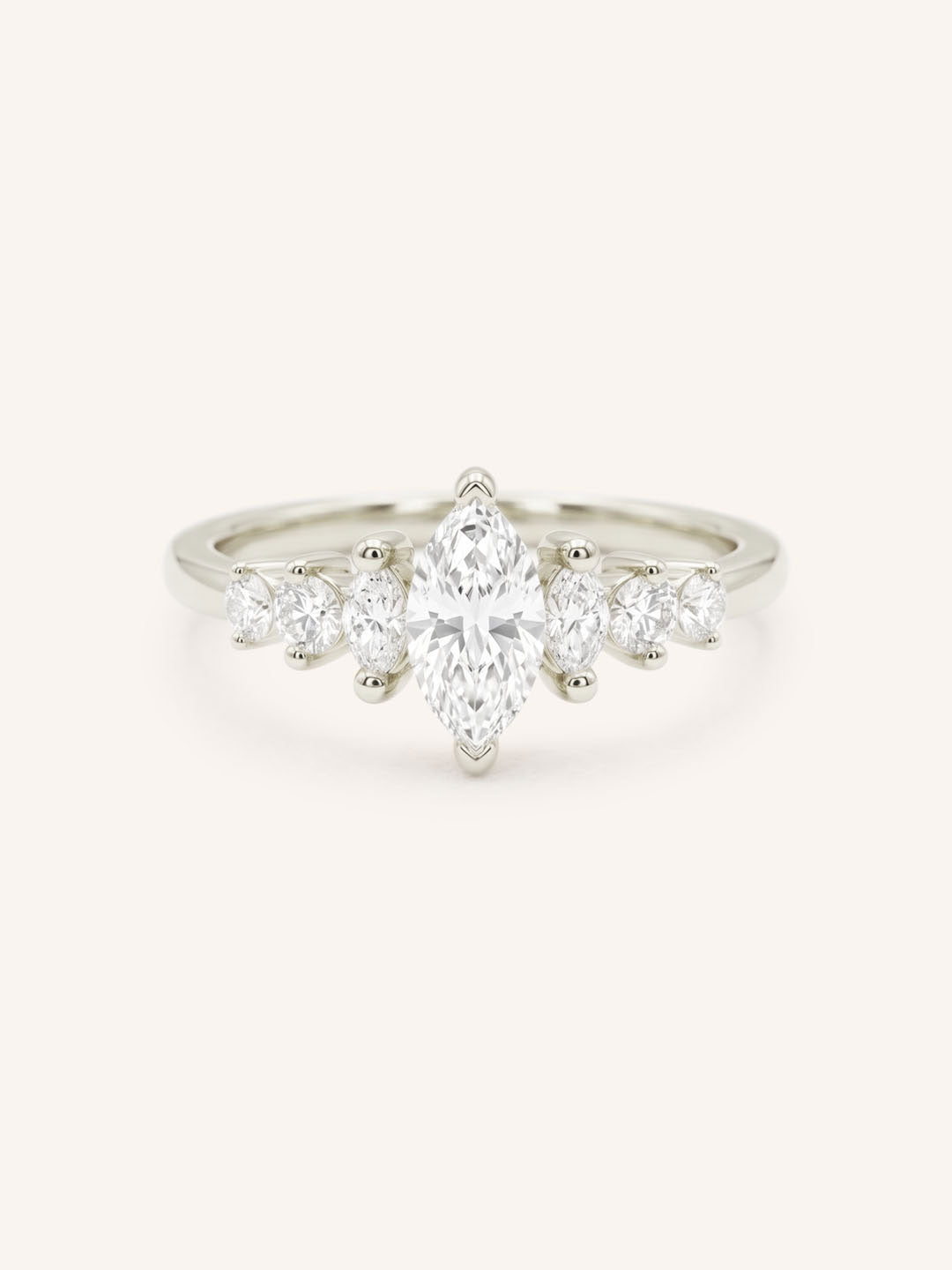White Gold marquise diamond ring with graduated marquise and round side stones on white background