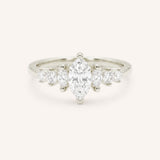 White Gold marquise diamond ring with graduated marquise and round side stones on white background