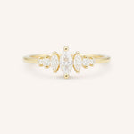 Gold ring with three Marquise diamonds and four round diamonds on a white background