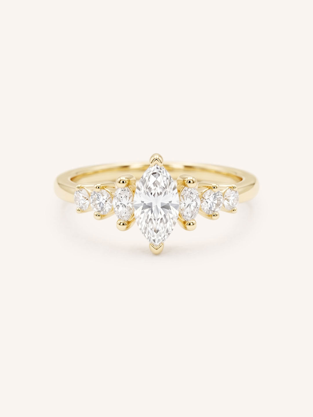 Yellow Gold marquise diamond ring with graduated marquise and round side stones on white background