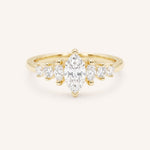 Yellow Gold marquise diamond ring with graduated marquise and round side stones on white background