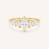 Yellow Gold marquise diamond ring with graduated marquise and round side stones on white background