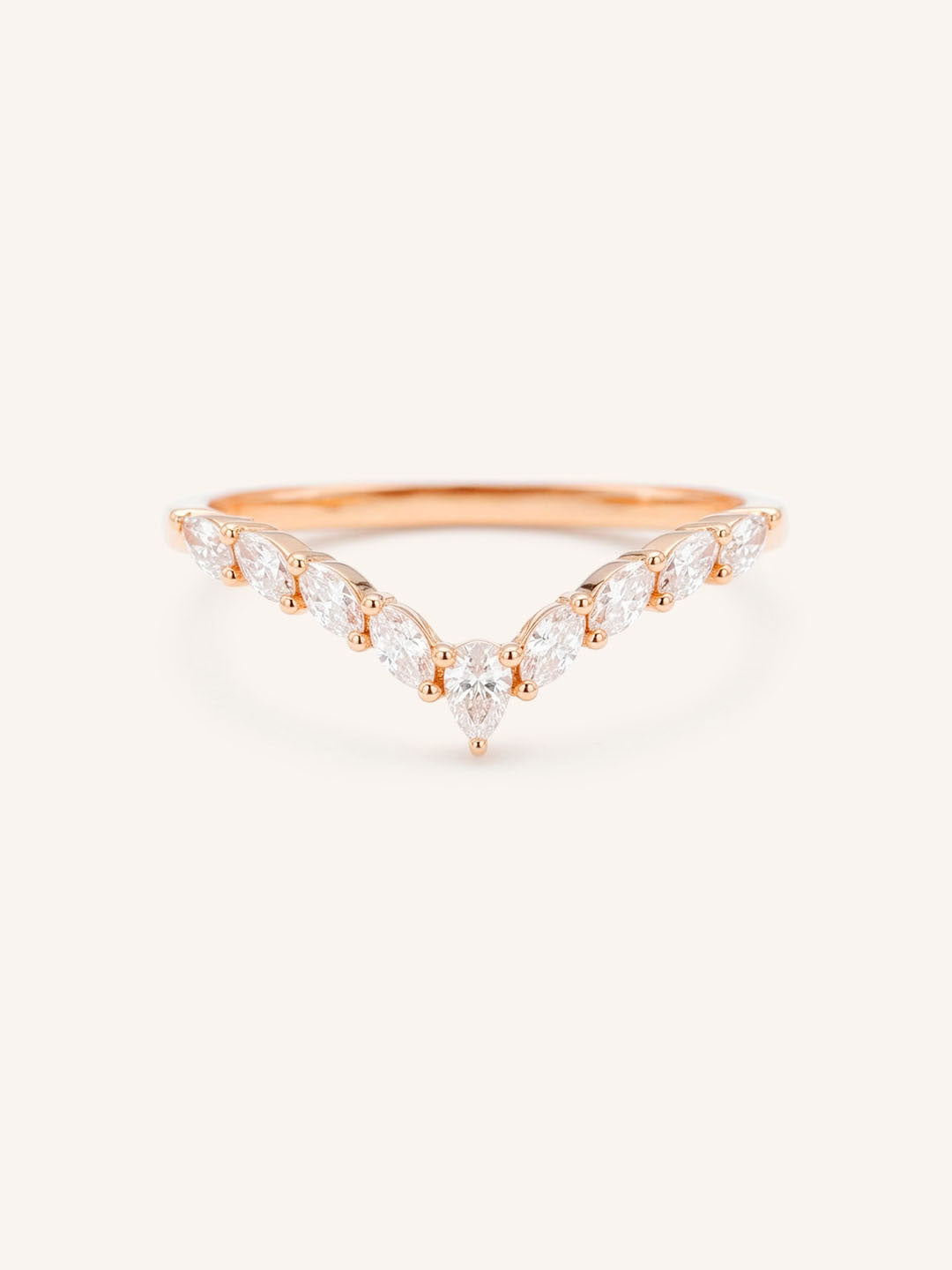 Rose gold ring with diamonds on a white background