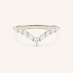 Delicate white gold ring with small diamonds on a white background