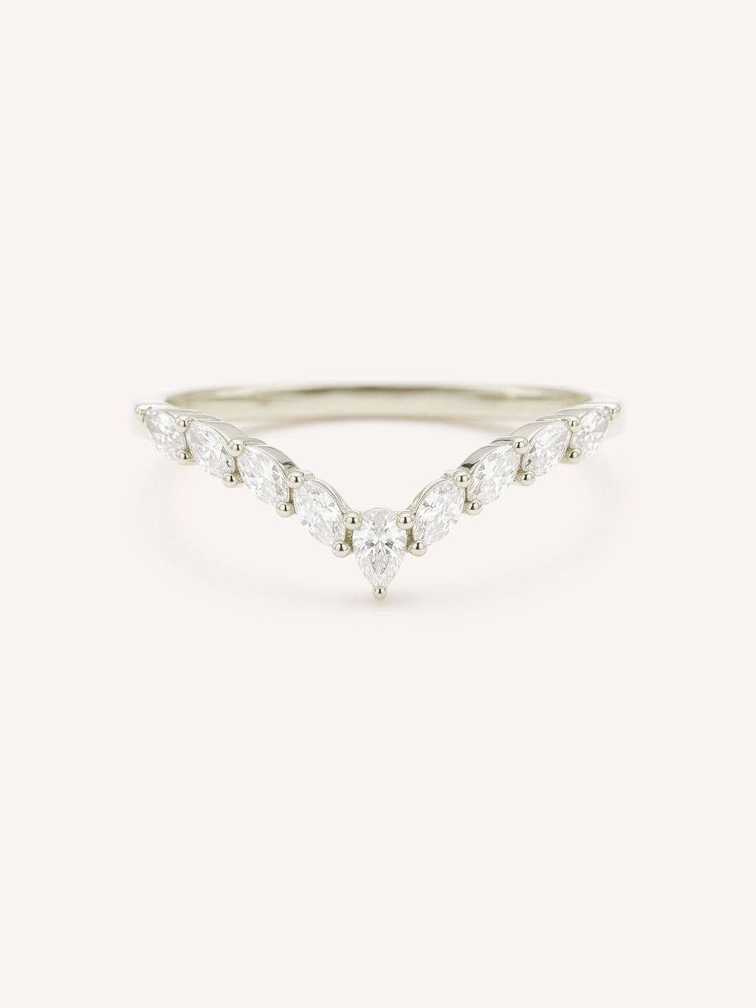 Delicate white gold ring with small diamonds on a white background