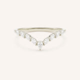Delicate white gold ring with small diamonds on a white background