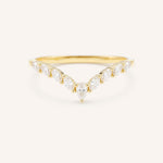 Curved Gold ring with diamonds on a white background