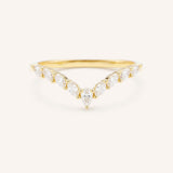 Curved Gold ring with diamonds on a white background