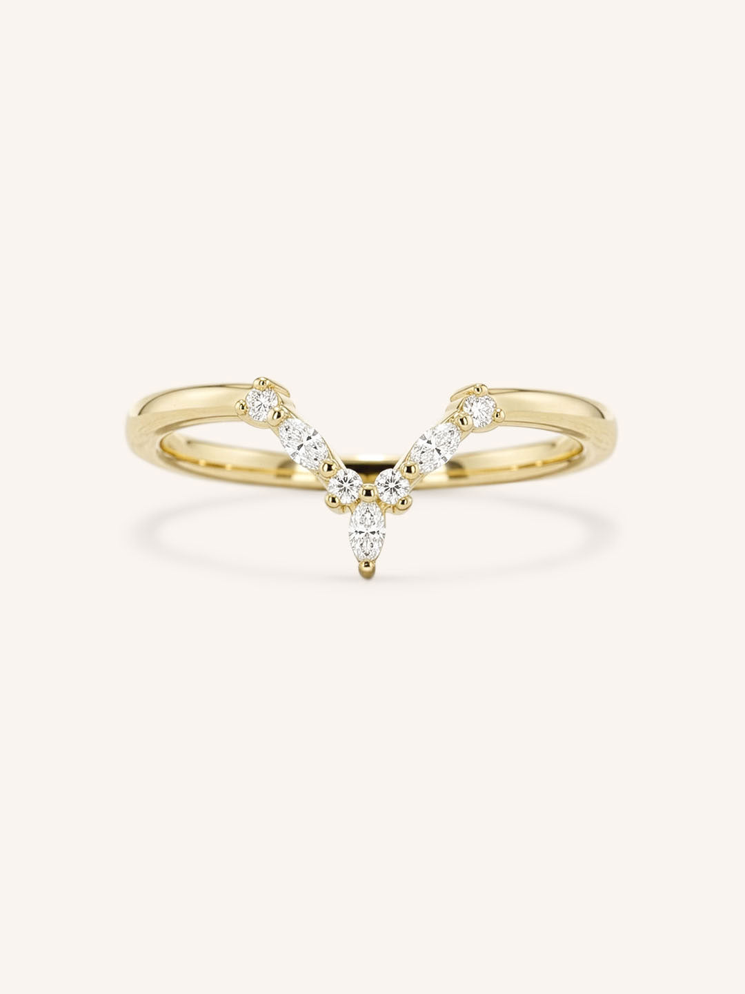 Yellow gold curved V-shaped pave diamond wedding band on white background