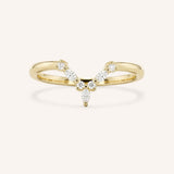 Yellow gold curved V-shaped pave diamond wedding band on white background