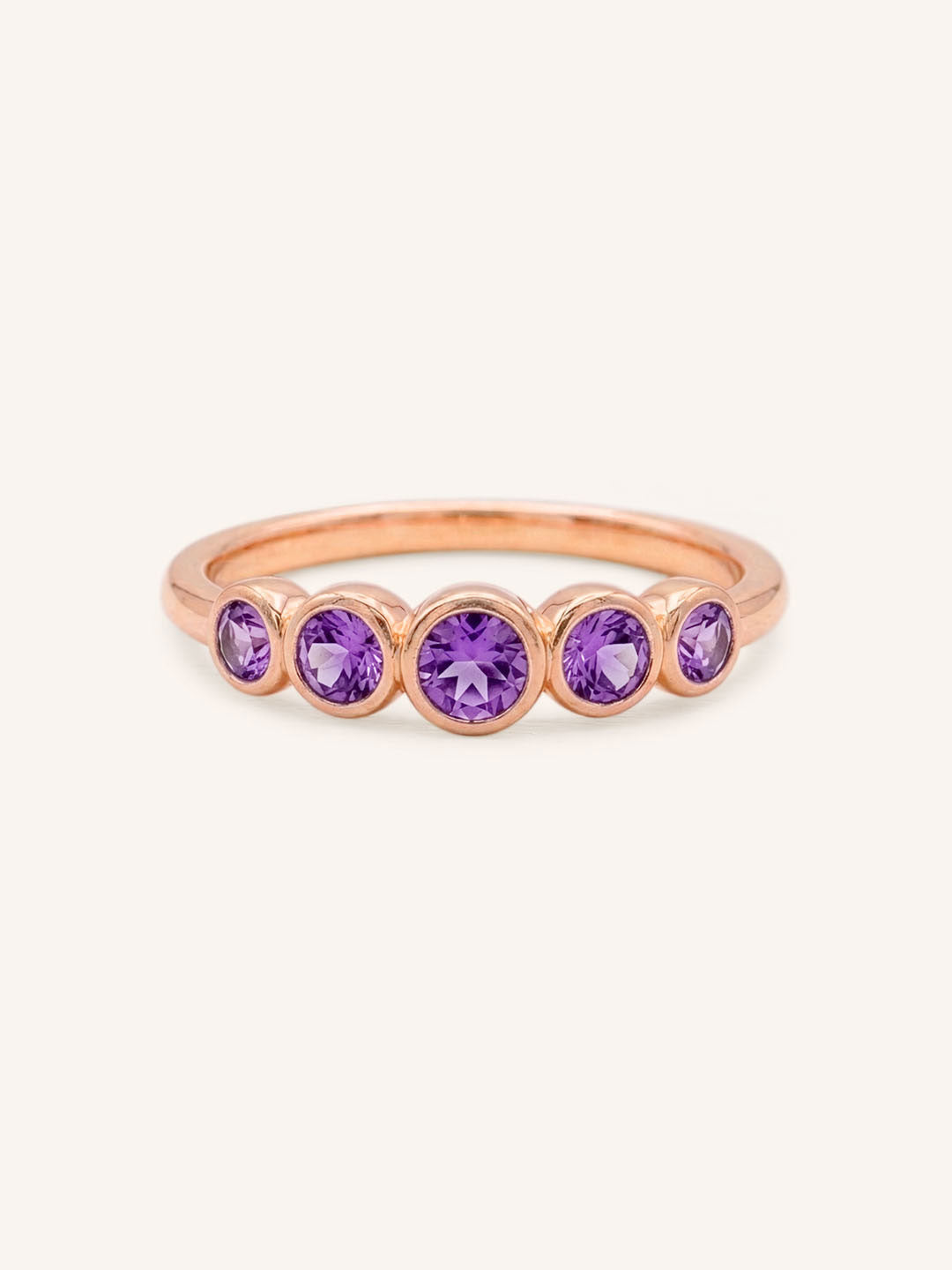Rose gold Bonneau five stone amethyst bezel ring front view on white background