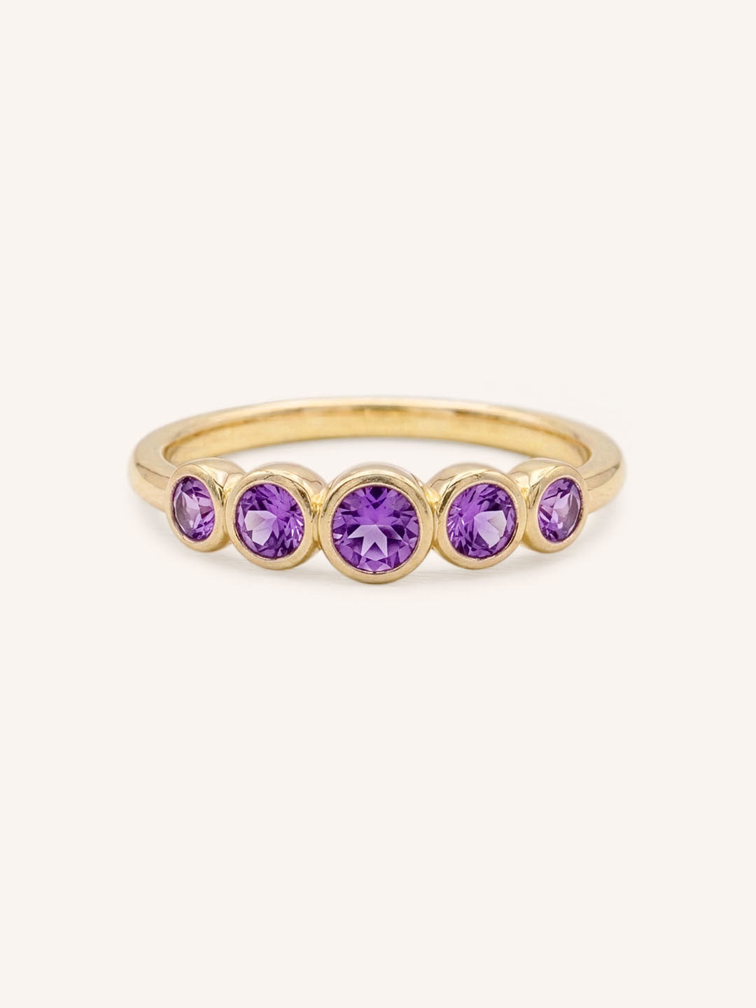 Yellow gold Bonneau five stone amethyst bezel ring front view on white background