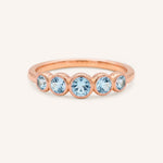 Rose gold Bonneau five stone aquamarine bezel ring front view on white background