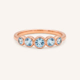 Rose gold Bonneau five stone aquamarine bezel ring front view on white background