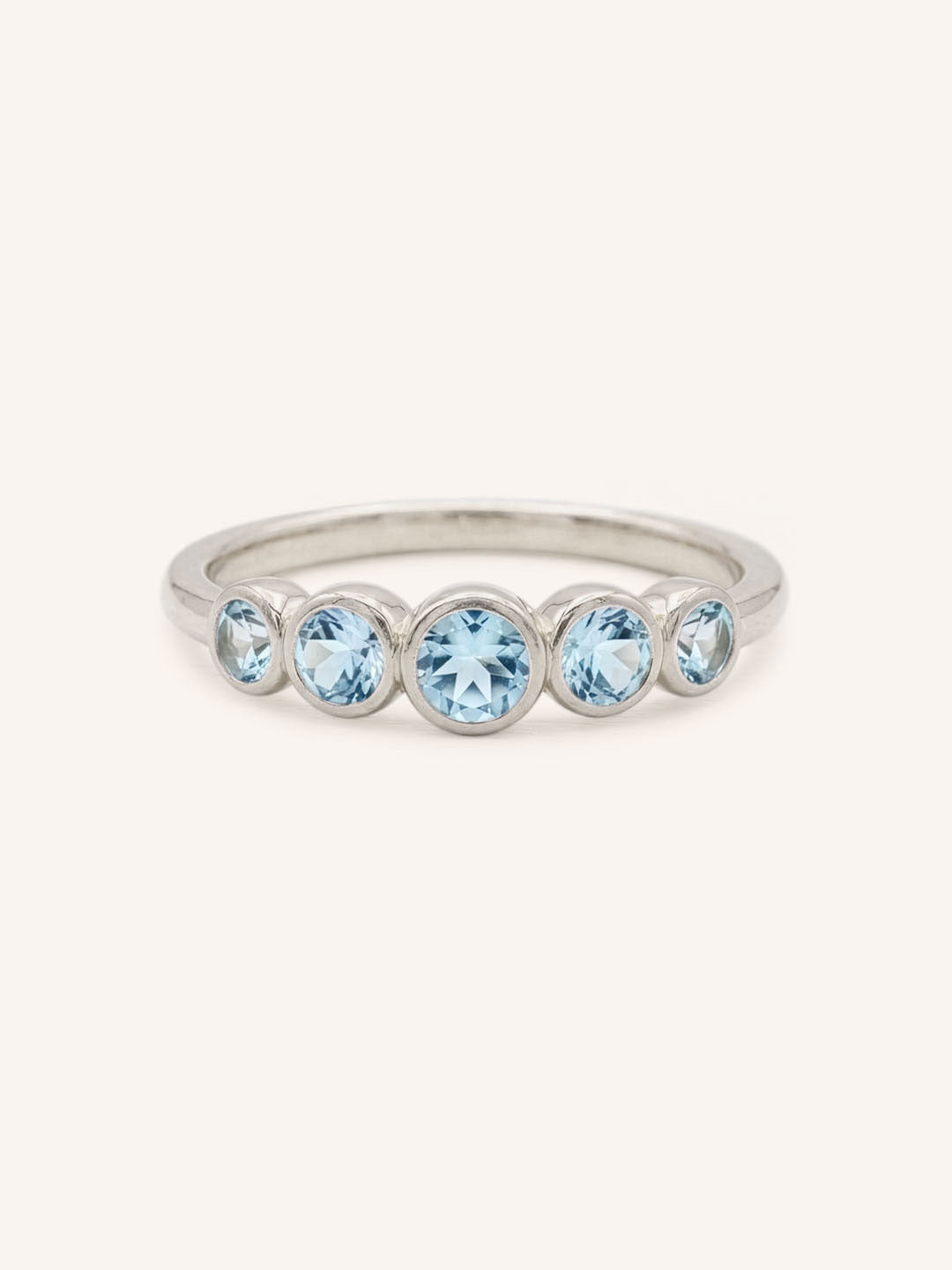 White gold Bonneau five stone aquamarine bezel ring front view on white background