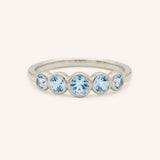White gold Bonneau five stone aquamarine bezel ring front view on white background