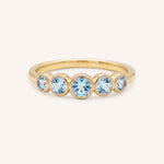 Yellow gold Bonneau five stone aquamarine bezel ring front view on white background