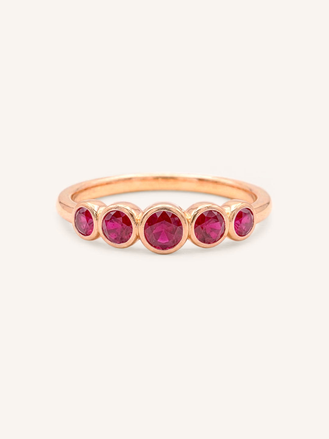 Rose gold Bonneau five stone ruby bezel ring front view on white background