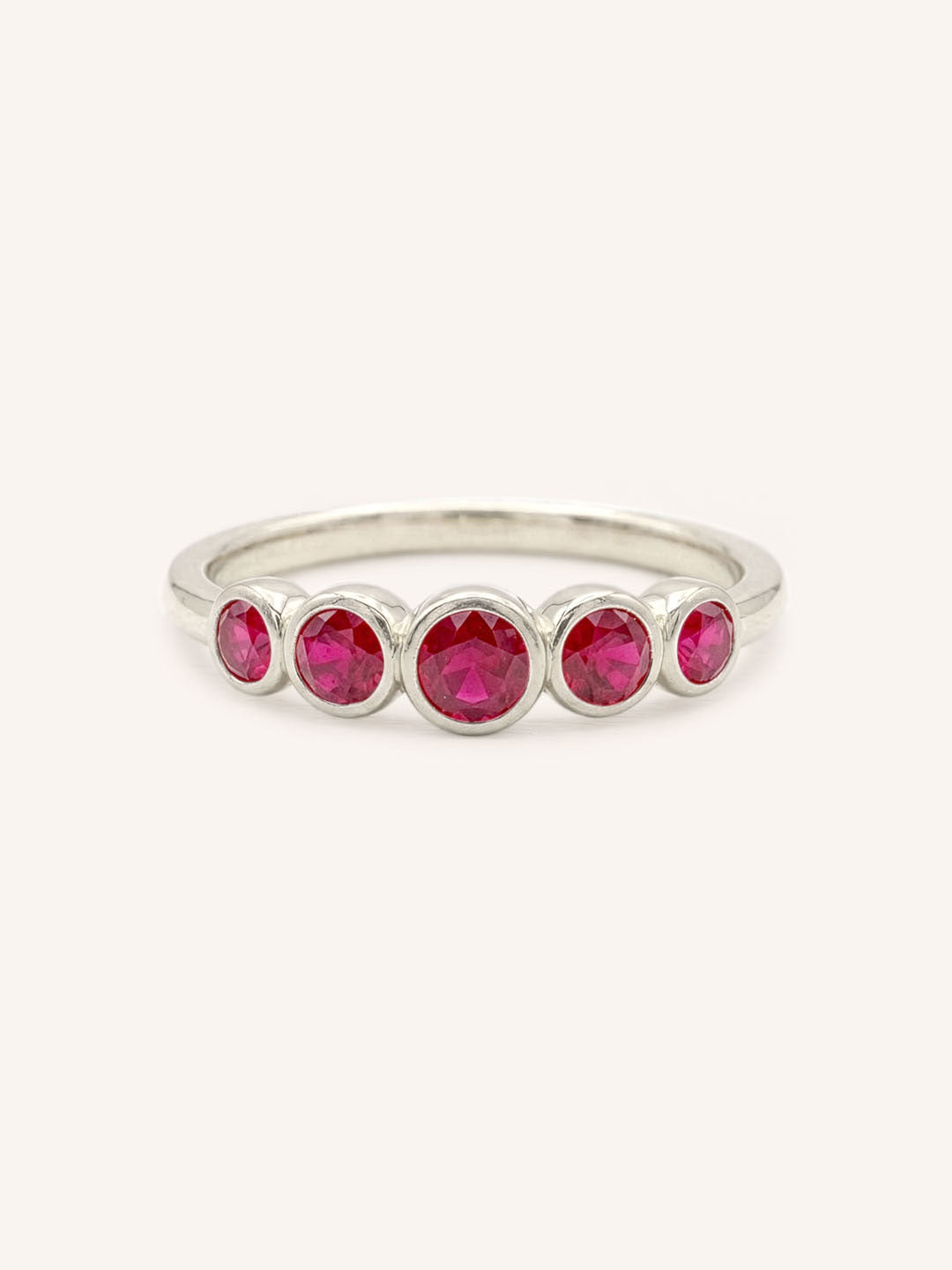 White gold Bonneau five stone ruby bezel ring front view on white background