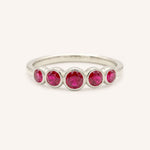 White gold Bonneau five stone ruby bezel ring front view on white background