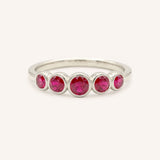 White gold Bonneau five stone ruby bezel ring front view on white background
