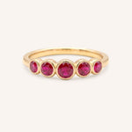 Yellow gold Bonneau five stone ruby bezel ring front view on white background