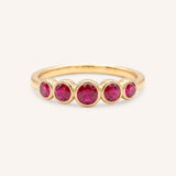 Yellow gold Bonneau five stone ruby bezel ring front view on white background
