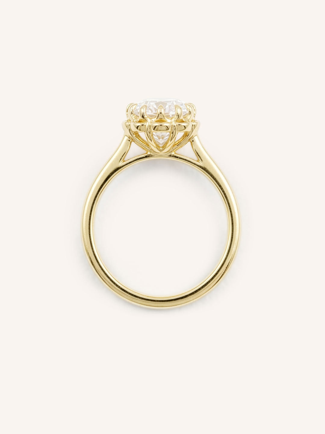 Yellow gold Jenner oval diamond solitaire engagement ring top view on white background
