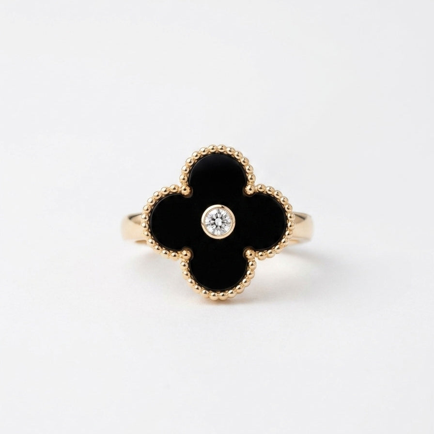Black onyx clover diamond ring on white background