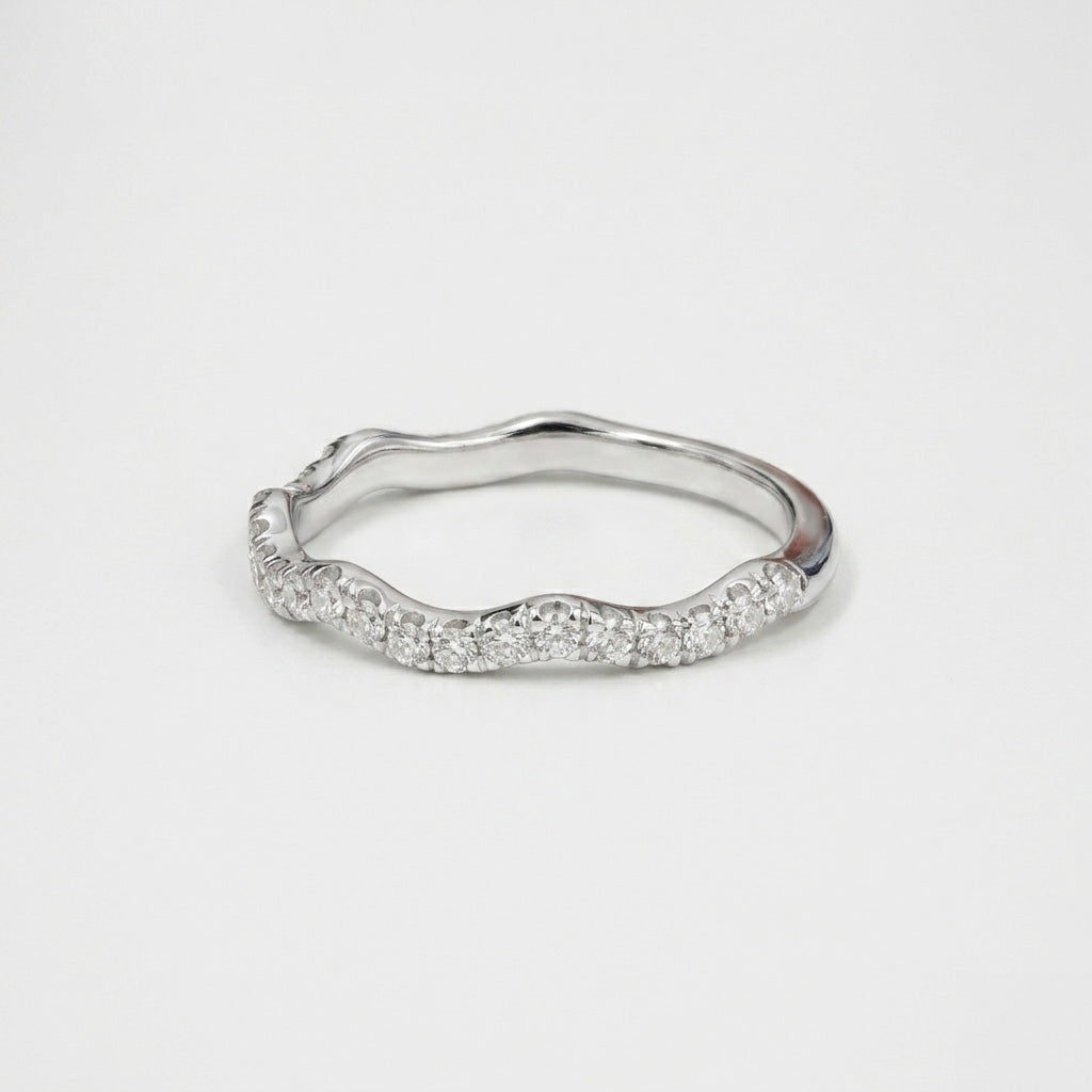 Diamond scalloped wave band ring on white background