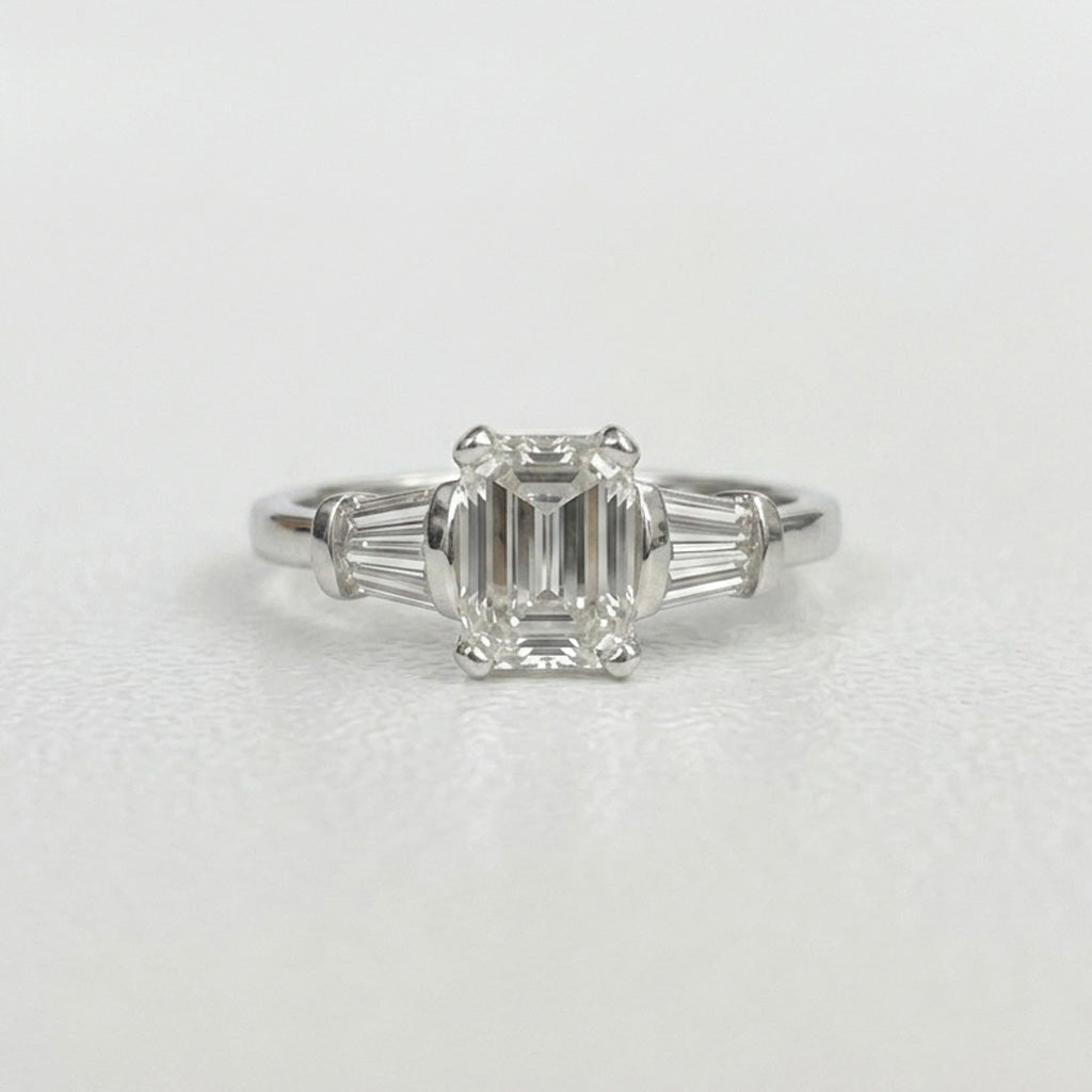 Emerald cut baguetteYellow gold Zamora curved diamond anniversary band front view on white background three stone engagement ring on white background