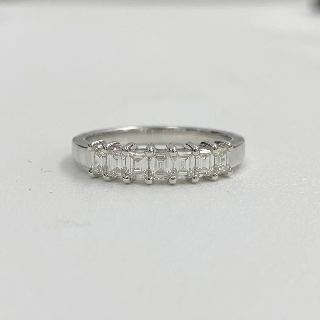 Emerald cut diamond five stone wedding band ring on white background