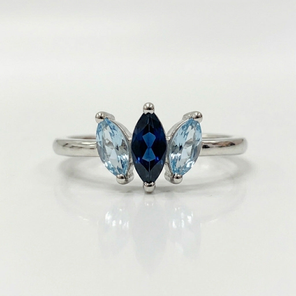Marquise aquamarine three stone ring on white background