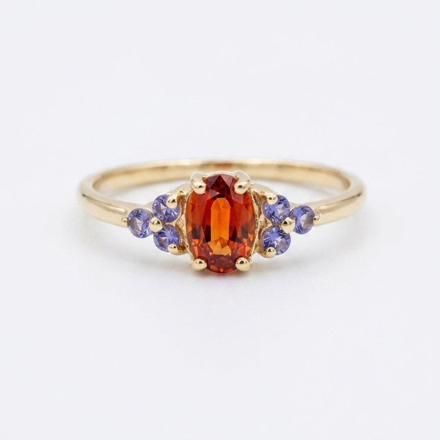 Orange tanzanite cluster ring on white background