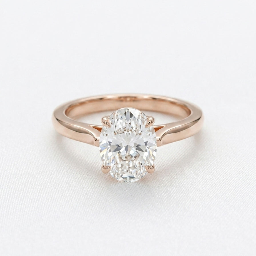 Oval diamond solitaire rose gold ring on white background