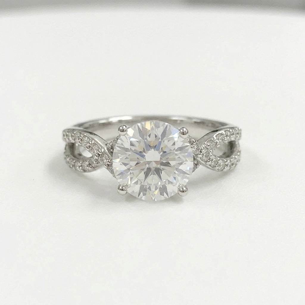 Round cut diamond twisted infinity band ring on white background